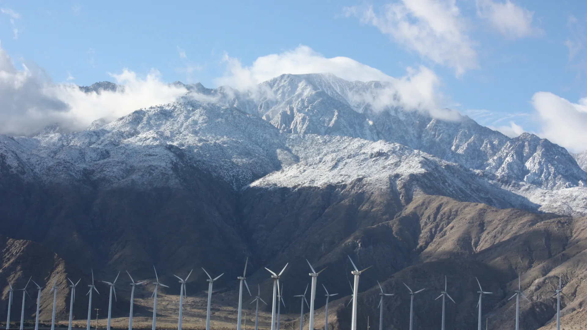 Wind turbines below the snowy San Jacinto Mountains near Palm Springs